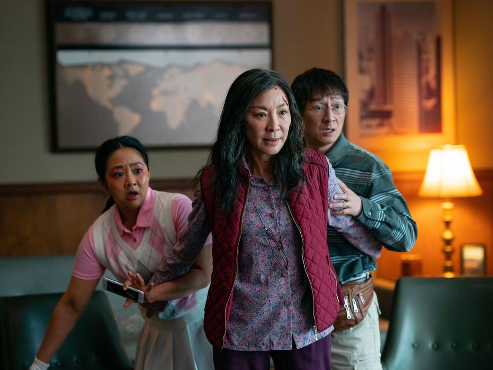 Michelle Yeoh (front), Ke Huy Quan, and Stephanie Hsu in <em>Everything Everywhere All at Once.</em>