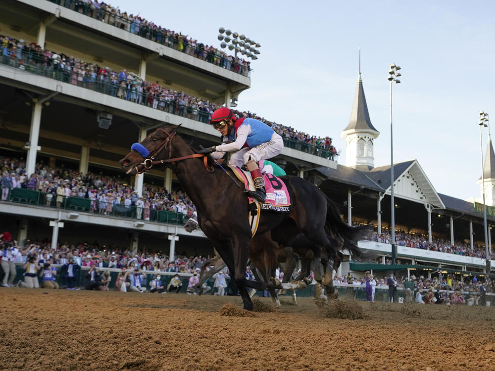 John Velazquez rides Medina Spirit across the finish line at the Kentucky Derby at Churchill Downs in Louisville, Ky., in May 2021. Medina Spirit failed a post race drug test and on Monday, was stripped of his 2021 title.