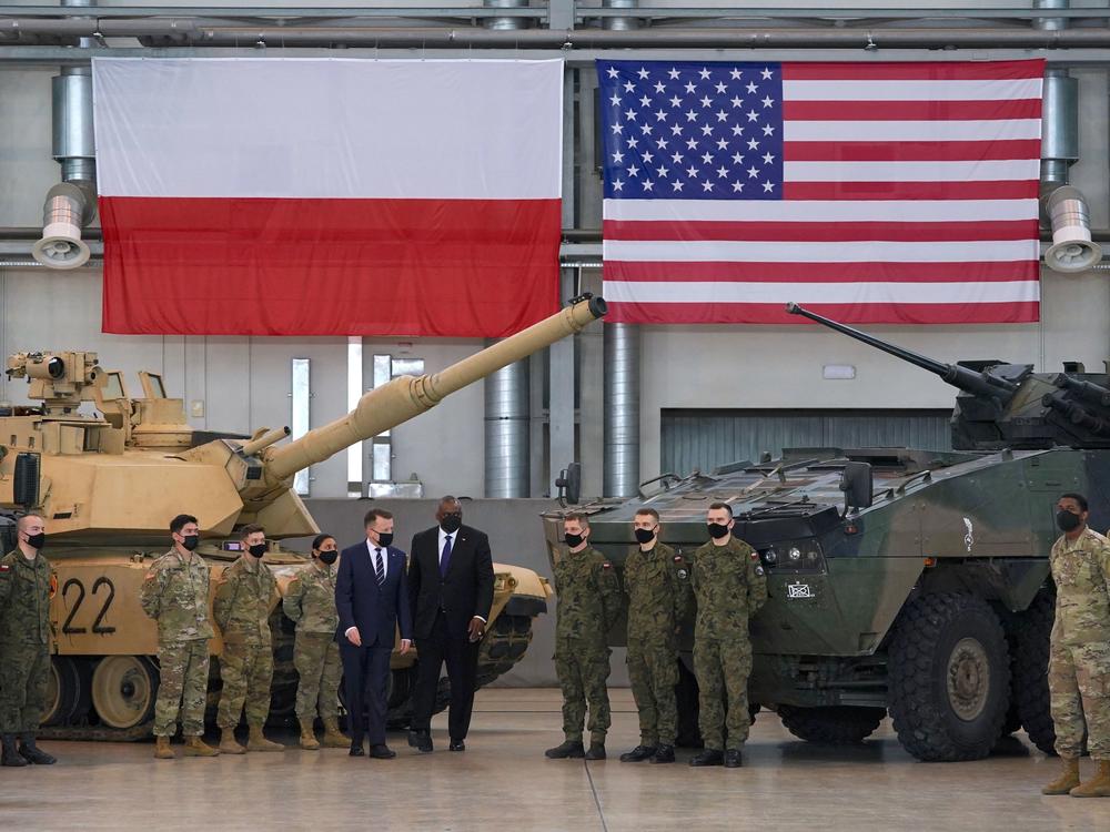 Secretary of Defense Lloyd Austin and Polish Defense Minister Mariusz Blaszczak stand with Polish and U.S. soldiers at the 33rd Air Base of the Polish Air Force near Powidz during a visit last week.