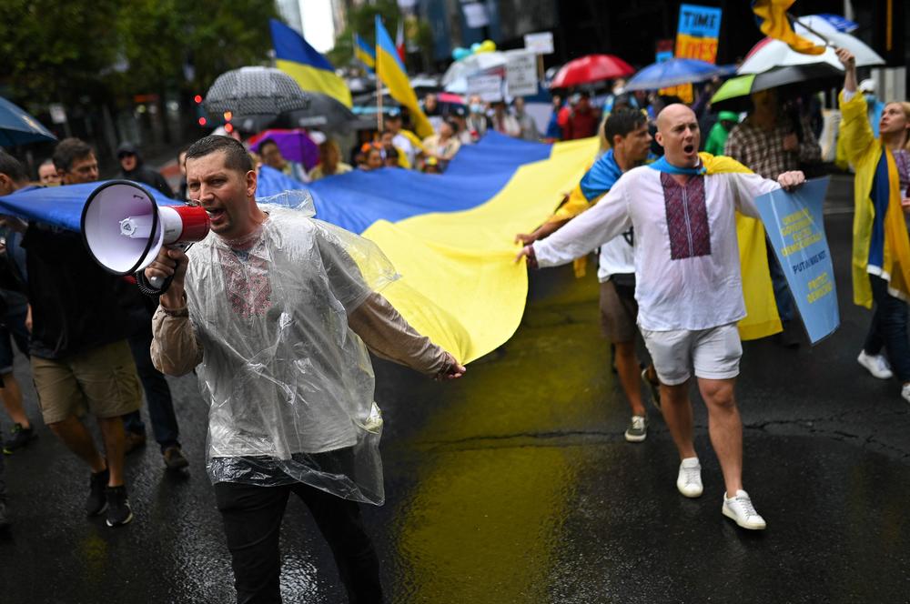 Members of the Australian-Ukrainian community carry a Ukrainian flag during a protest against Russia's invasion of Ukraine, in Sydney on Saturday.