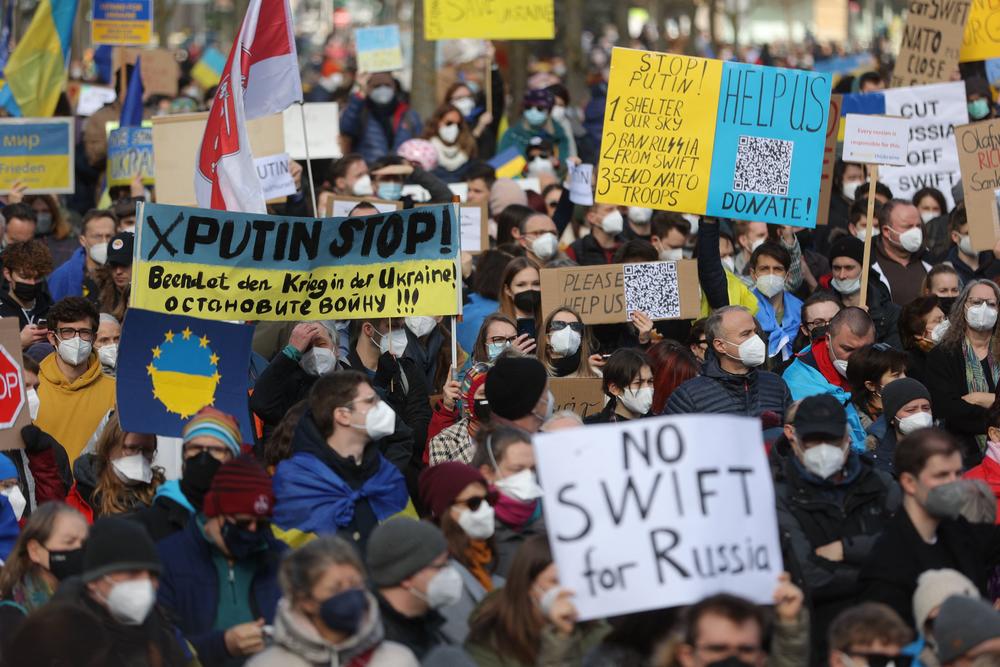 People take part in a protest against Russia's invasion of Ukraine on Saturday in Frankfurt am Main, western Germany.