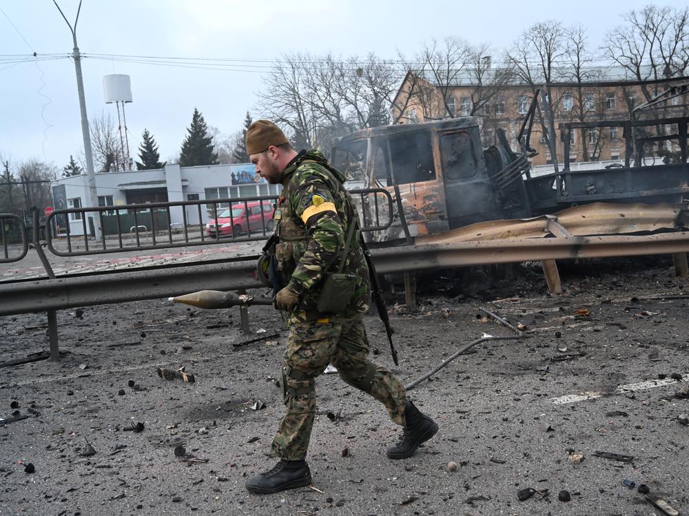 Ukrainian service members collect unexploded shells after fighting with Russian forces in the Ukrainian capital of Kyiv in the morning of Feb. 26, 2022, according to Ukrainian service personnel at the scene.