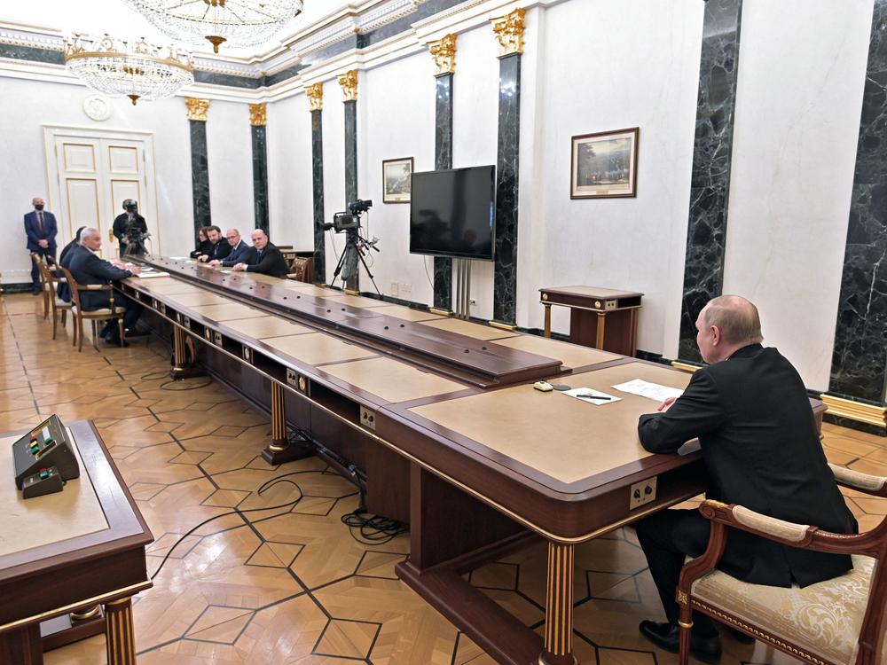 Russian President Vladimir Putin chairs a meeting on economic issues at the Kremlin on Monday as the ruble fell and Russia's central bank raised its key interest rate to a historic high.
