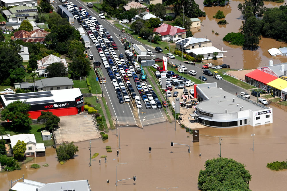 In an aerial view, vehicles are seen stuck along a street as floodwaters surround Gympie, Australia, on Sunday in an area north of Sunshine Coast.