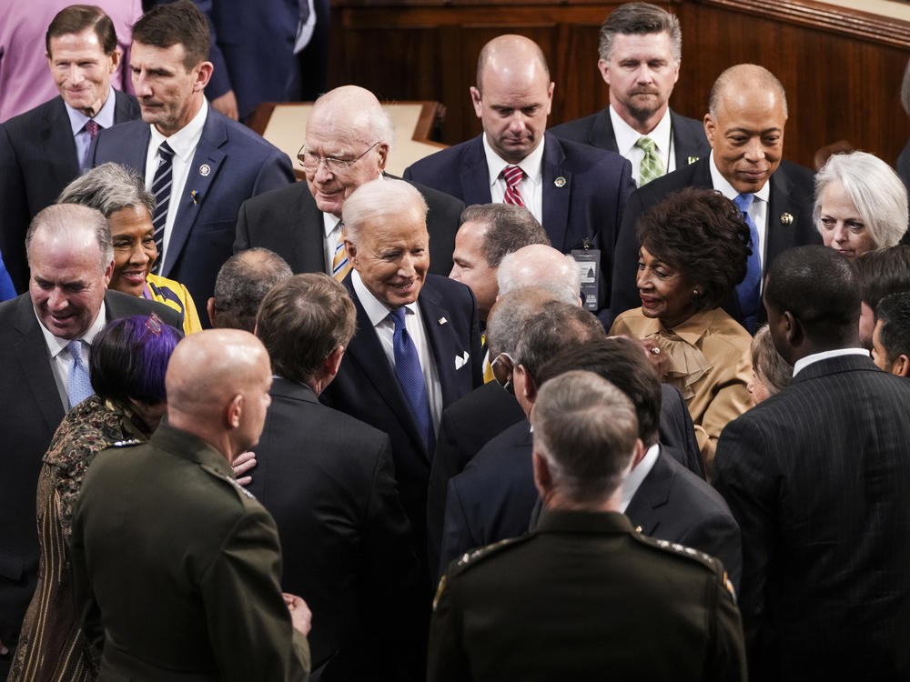 President Biden talks to lawmakers after delivering his State of the Union address on Tuesday.