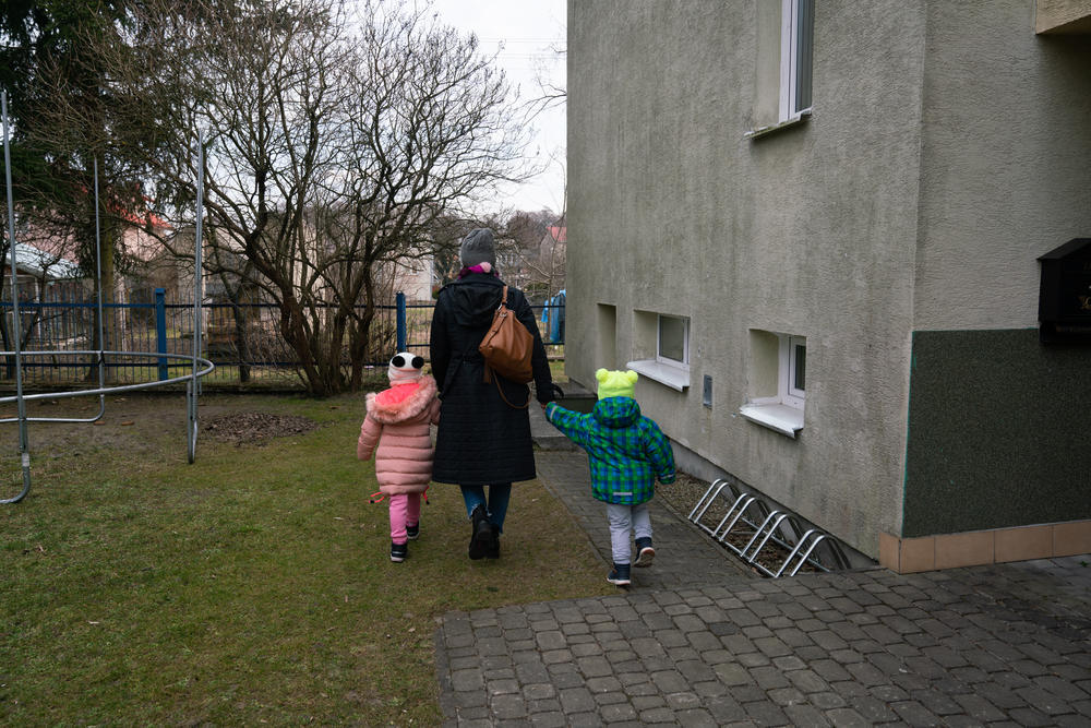 A caretaker at an SOS Children's Village in Bilgoraj, Poland, walks children through the property.