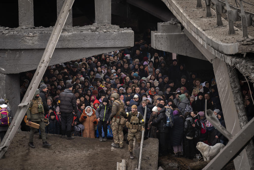<strong>March 5:</strong> Ukrainians crowd under a destroyed bridge as they try to flee crossing the Irpin river in the outskirts of Kyiv, Ukraine.