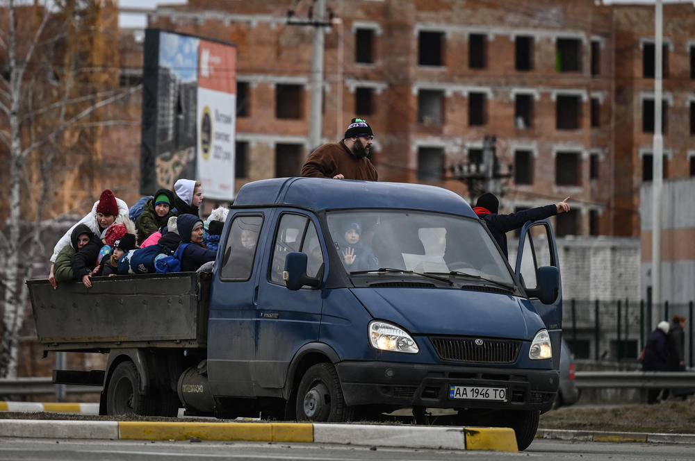 <strong>March 5:</strong> People sit in a car as as they evacuate the city of Irpin, northwest of Kyiv, during heavy shelling and bombing.