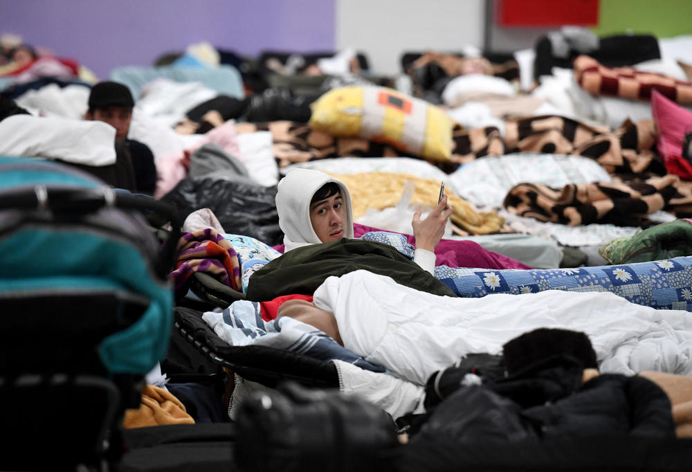 <strong>March 5:</strong> A man lies on a camp bed in a refugee reception center at the Ukrainian-Polish border crossing in Korczowa.