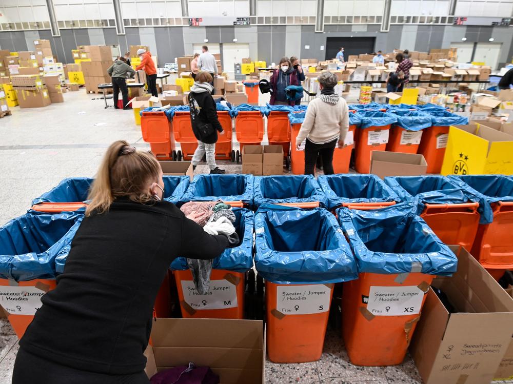 Volunteers from the aid organization Borderless Warmth sort relief supplies for Ukraine in Dortmund, in western Germany.