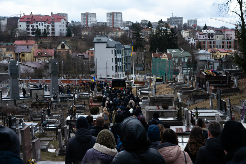 A funeral procession makes its way through the Lychakiv cemetery in Lviv, Ukraine, on Tuesday.
