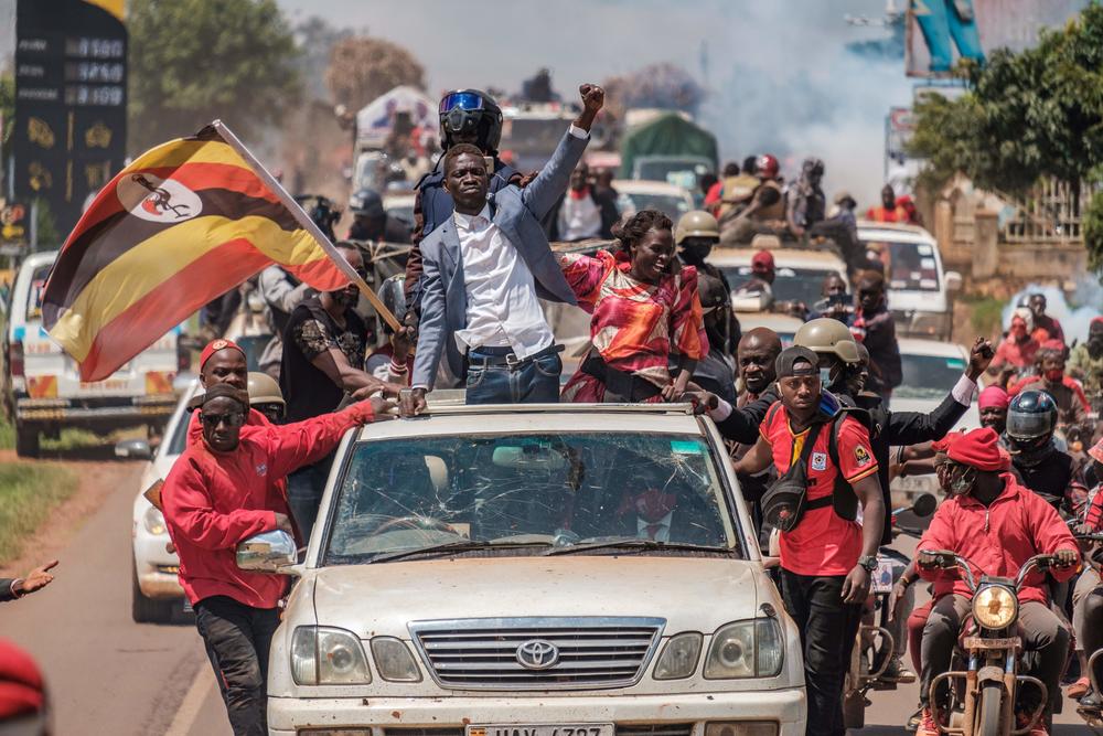 Ugandan musician-turned-politician Robert Kyagulanyi, also known as Bobi Wine, center, greets supporters as he sets off on his campaign trail towards eastern Uganda, near Kayunga, on Dec. 1, 2020.