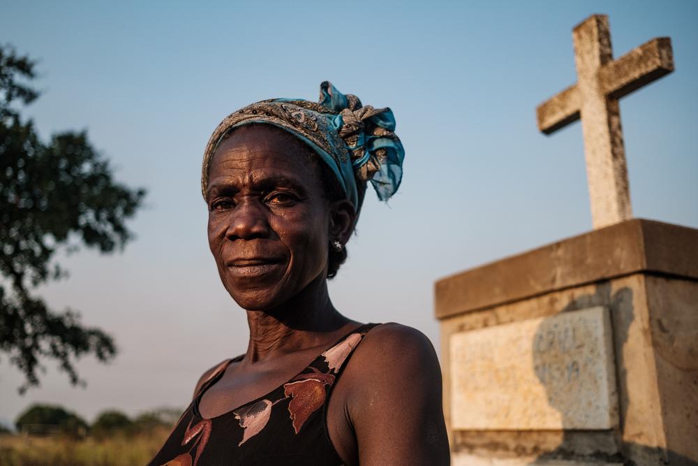 Margaret Labol, 50, who lost 15 family members and her husband, a Uganda People's Defence Force (UPDF) soldier, during the Lukodi massacre caused by the Lord's Resistance Army (LRA) in 2004, poses for a portrait in front of the memorial for the victims of the massacre in Lukodi, Uganda, Feb. 3, 2021.
