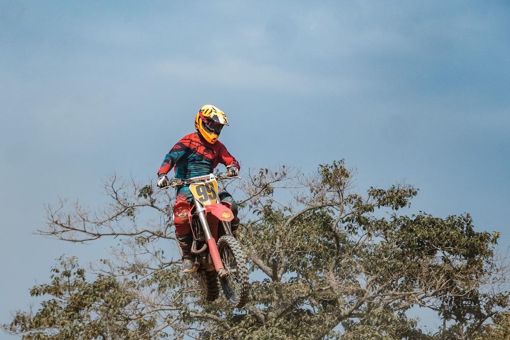 Arthur Blick Junior, one of Uganda's most well known racers,jumps with his bike at a motocross rally in Entebbe, on Jan. 30, 2022.
