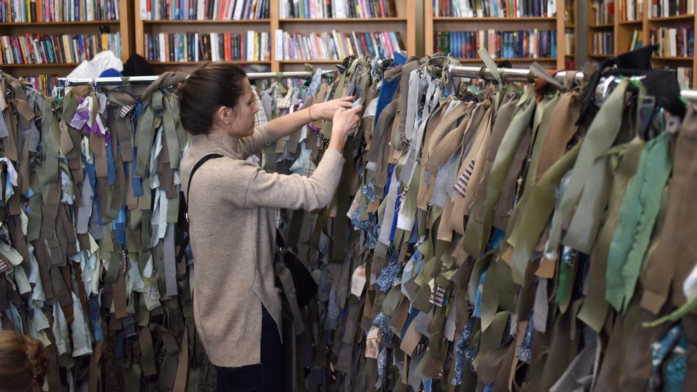 A volunteer makes camouflage nets for the Ukrainian military at a library in Lviv, in western Ukraine.