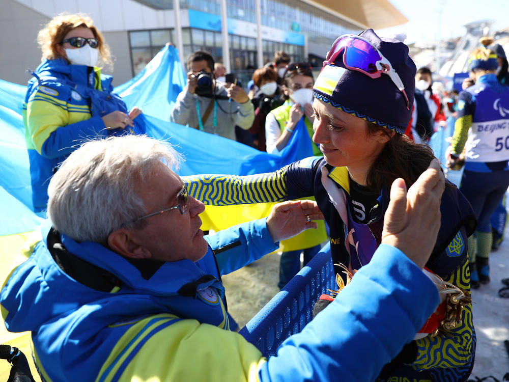 Gold medalist Iryna Bui of Team Ukraine celebrates with Valerii Sushkevych, the president of Ukraine's Paralympic committee, on Tuesday.