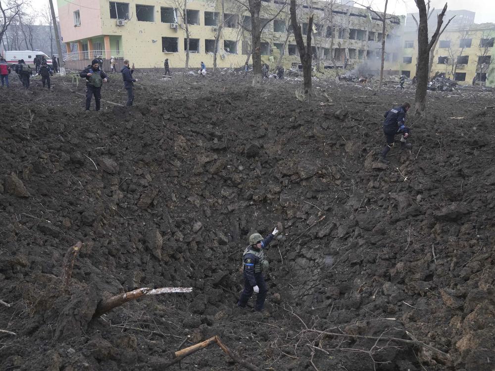 A massive crater sits outside of a maternity hospital that local officials say was severely damaged on Wednesday by a Russian attack in the besieged port city of Mariupol, Ukraine.