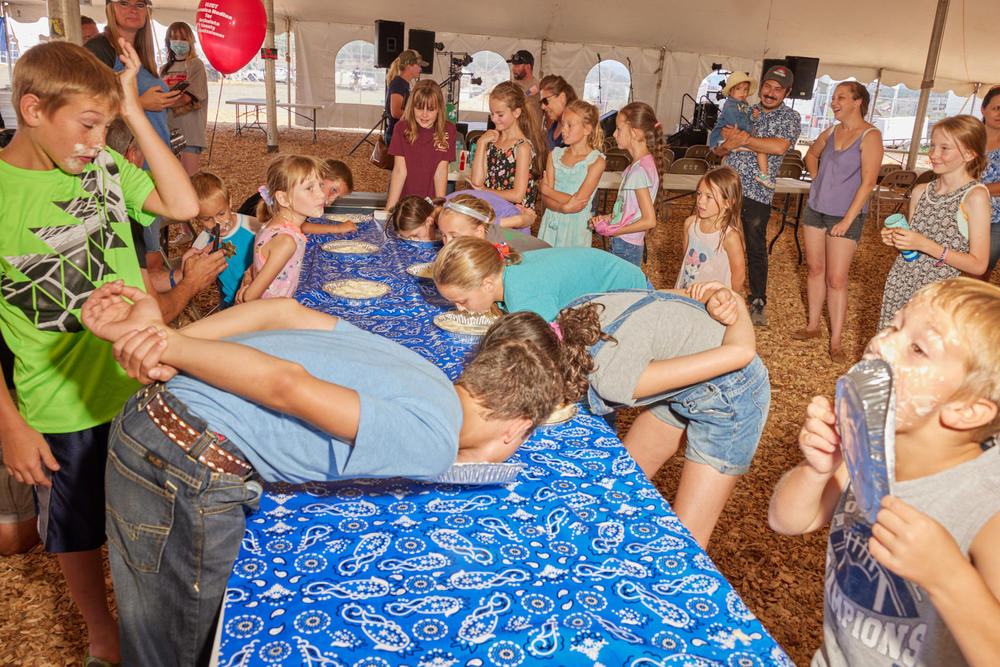 Children participate in the Archuleta County Fair's pie-eating contest in Pagosa Springs, Colo., on Aug. 5, 2021.