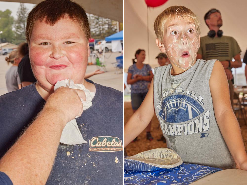 Two participants recover after the Moffat County Fair' pie-eating contest in Craig, Colo., on Aug. 7, 2021.