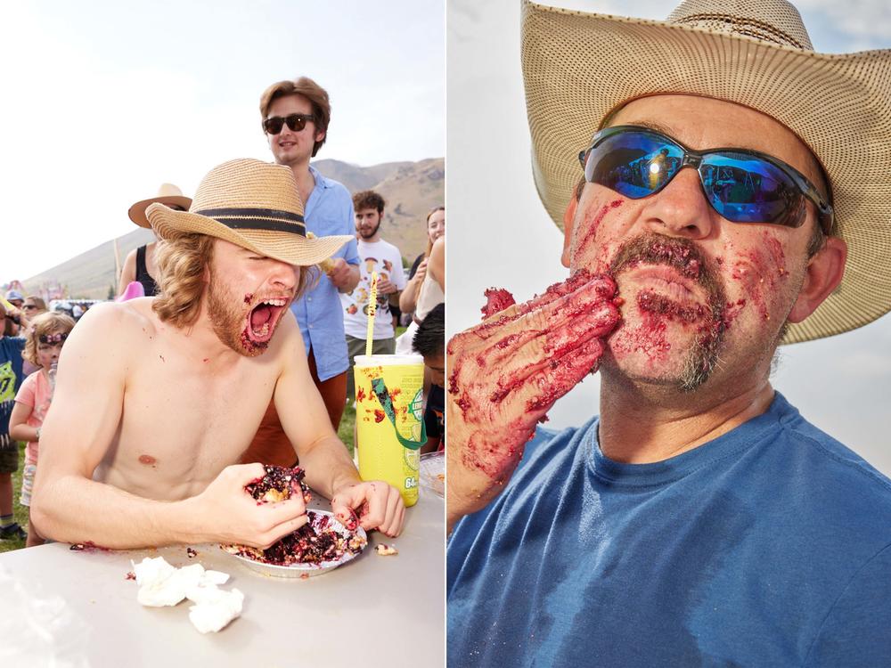 Two men participate in the Teton County Fair's pie-eating contest in Jackson, Wyo., on Aug. 1, 2021.