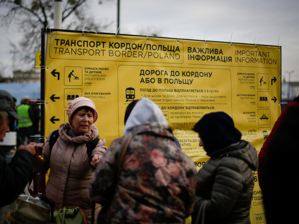 As people pour off the trains arriving in Lviv, signs offer guidance on transportation, shelter and other aid.