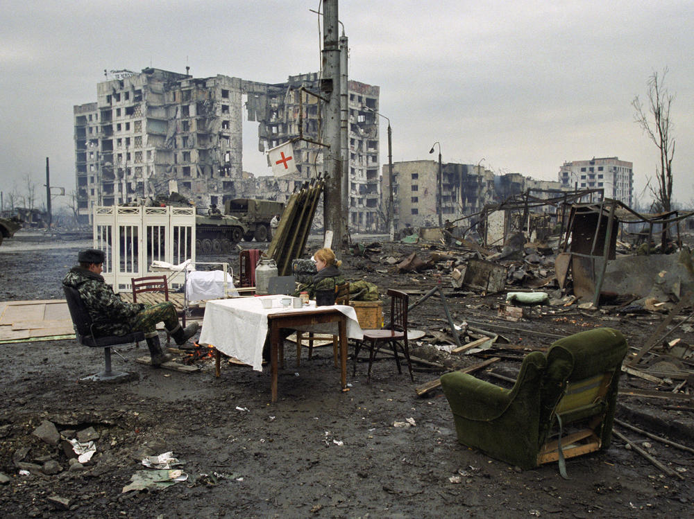 Russian soldiers rest in Chechnya's capital, Grozny, in February 2000. Russia waged two wars against Chechnya from 1994 to 2000. In both wars, Russia heavily bombed Chechnya, flattening Grozny and causing tens of thousands of civilian deaths.