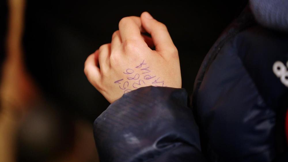 A phone number was written on Hassan's hand to help him reach relatives.
