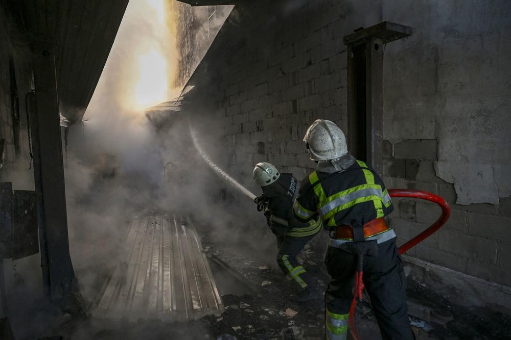 <strong>March 12:</strong> Firefighters extinguish a fire on a house after shelling on the 17th day of the Russian invasion of Ukraine, in Kyiv.