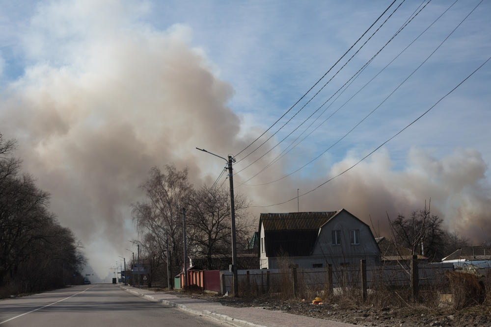 <strong>March 12:</strong> A view to the road and the smoke coming from the storage facility in Brovary, Ukraine.