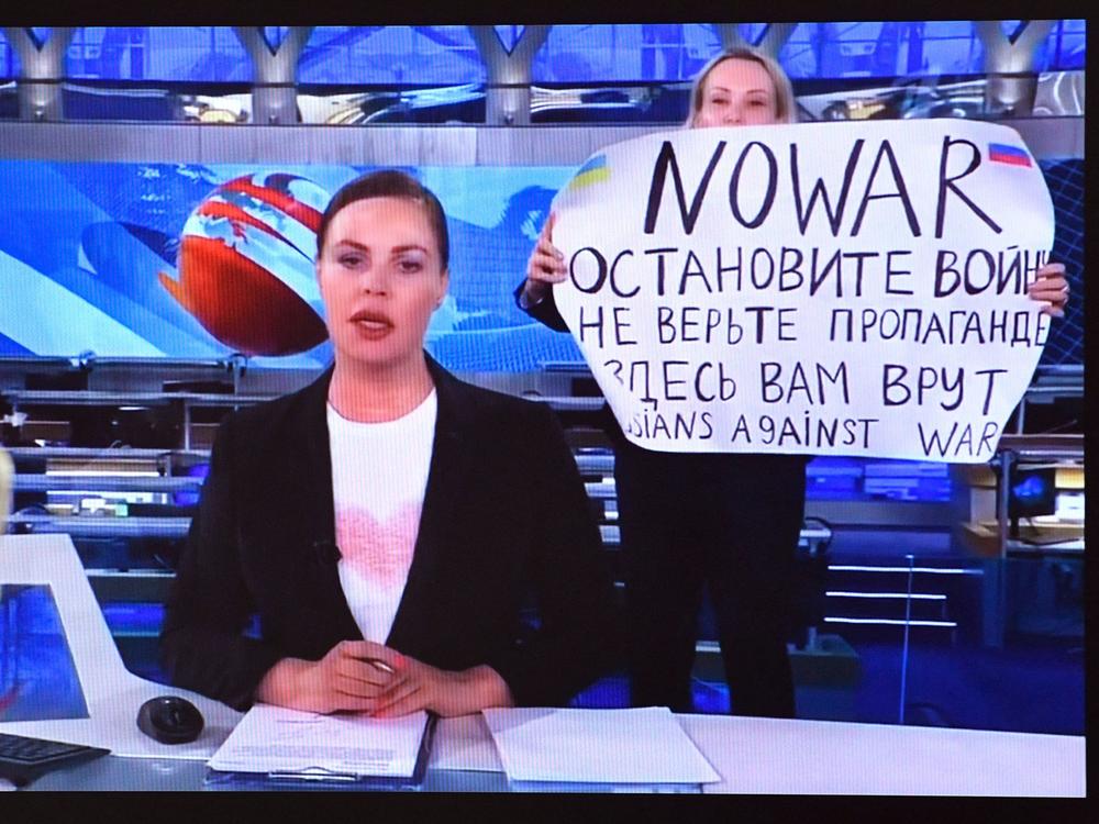A dissenting Channel One employee interrupted Russia's most-watched evening news broadcast, holding a poster reading 