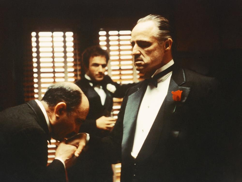 From left to right, Salvatore Corsitto as Bonasera, James Caan as Santino 'Sonny' Corleone and Marlon Brando (1924 - 2004) as Don Vito Corleone in 'The Godfather', 1972. Bonasera asks Don Corleone to avenge the brutal rape of his daughter.
