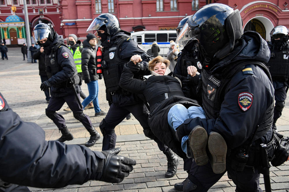 Police officers in central Moscow on March 13 detain a woman during a protest against Russian military action in Ukraine.