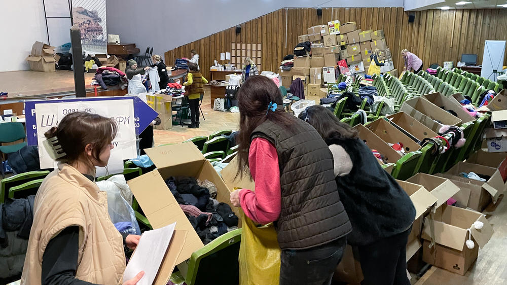 Women sort donated socks in a theater now being used as an aid distribution hub in downtown Lviv, Ukraine.