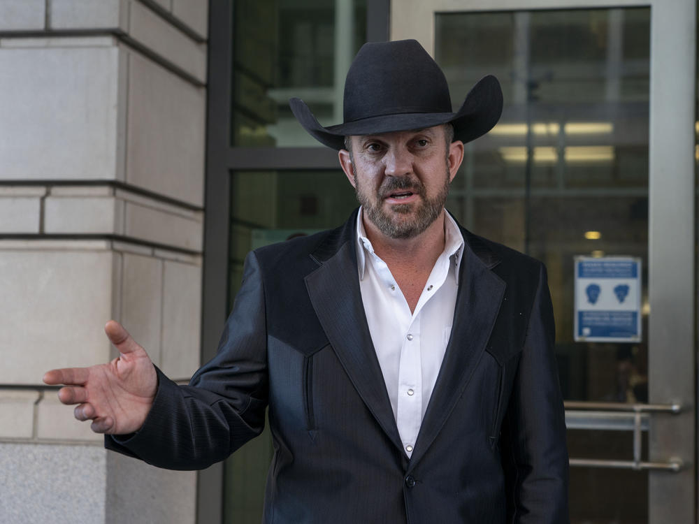 Couy Griffin, a commissioner in Otero County, N.M., speaks to journalists as he leaves the federal court in Washington, D.C., on March 21, 2022.