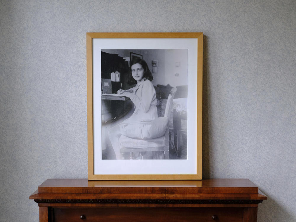 A photo of Anne Frank stands on a replica of the writing desk she once used in her family's former apartment in Amsterdam, during an event to mark what would have been Anne Frank's 90th birthday, in Amsterdam in June 2019.