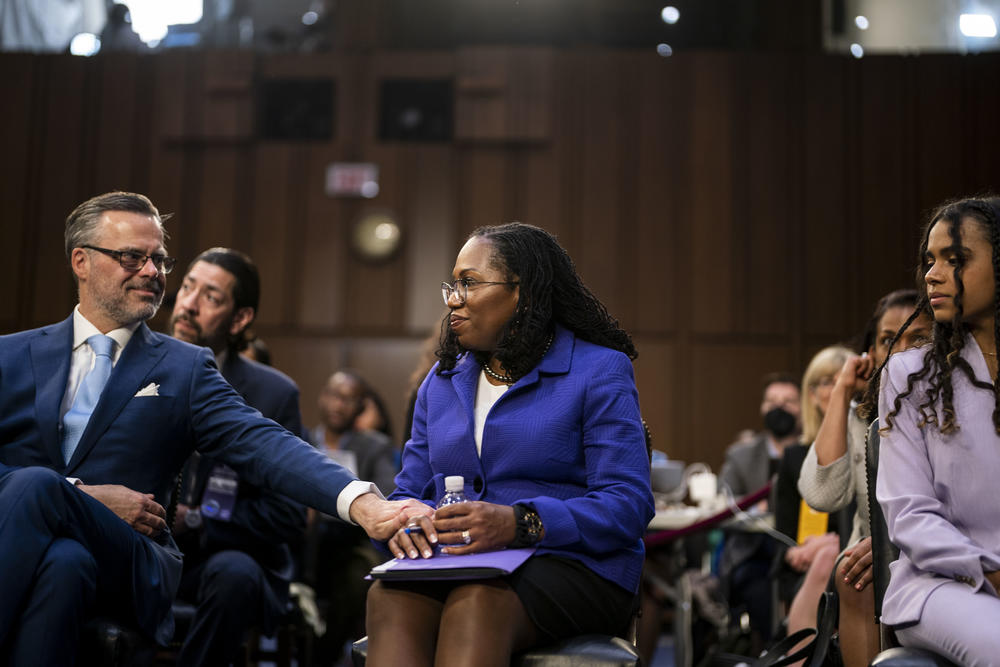 <strong>March 21:</strong> Patrick Jackson, the husband of Supreme Court nominee Judge Ketanji Brown Jackson, reaches out to hold her hand as she sits in the audience area with her family during her Senate Judiciary Committee confirmation hearing.