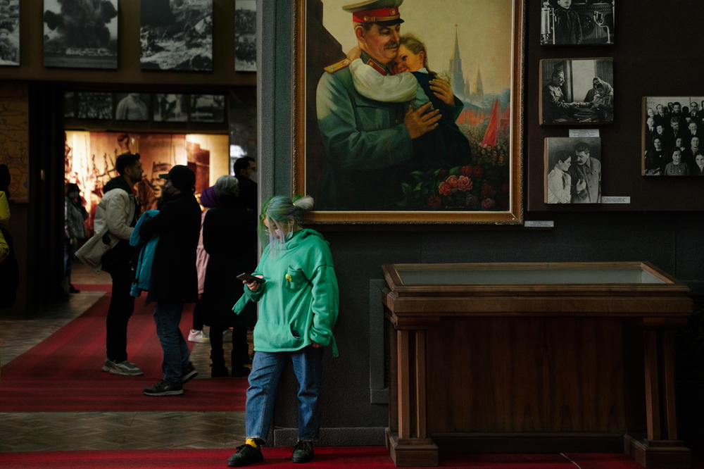 A person stands in front of a painting in the Stalin museum in Gori.