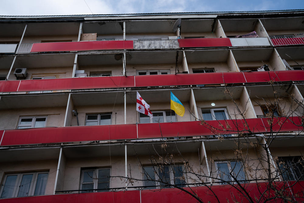 A Ukranian flag and a Georgian flag wave outside a residential building in Gori, across the street from the Stalin museum.