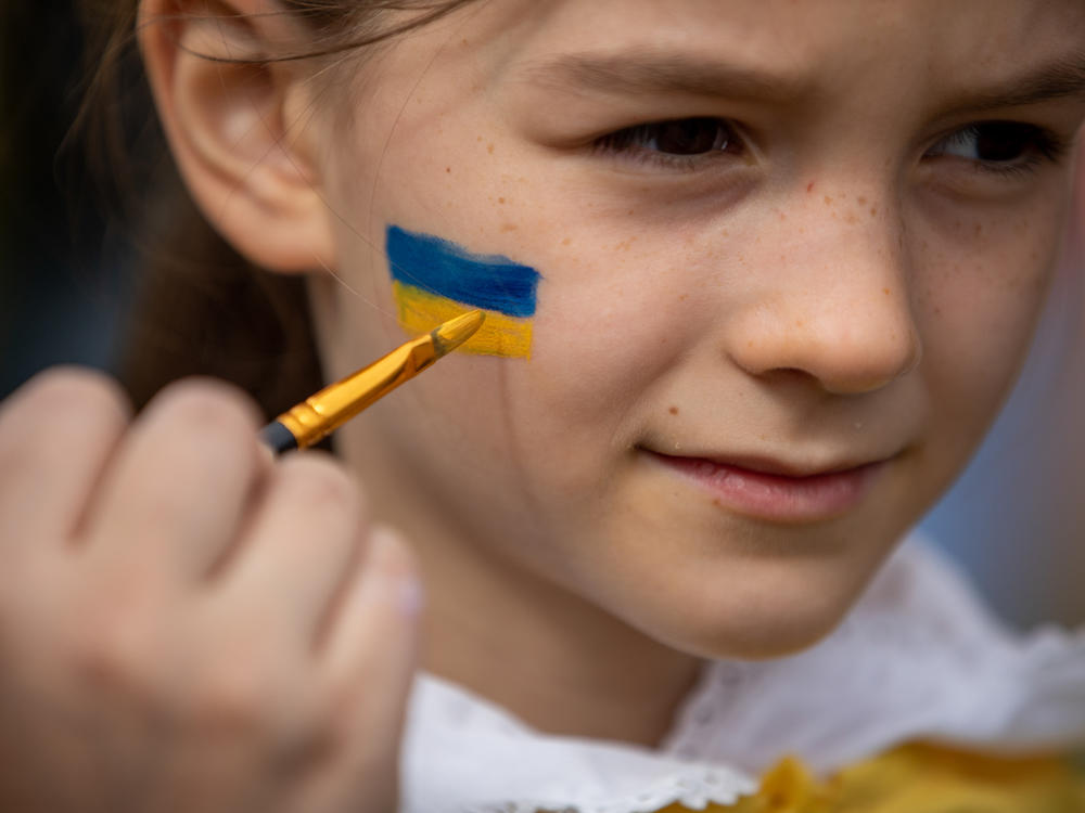 <strong>March 20:</strong> Rachel Nockles, 7, gets a Ukrainian flag painted on her face at a STANDwithUKRAINE rally in front of the White House. Her mother is from Ukraine, but her family now lives in Bethesda, Maryland.