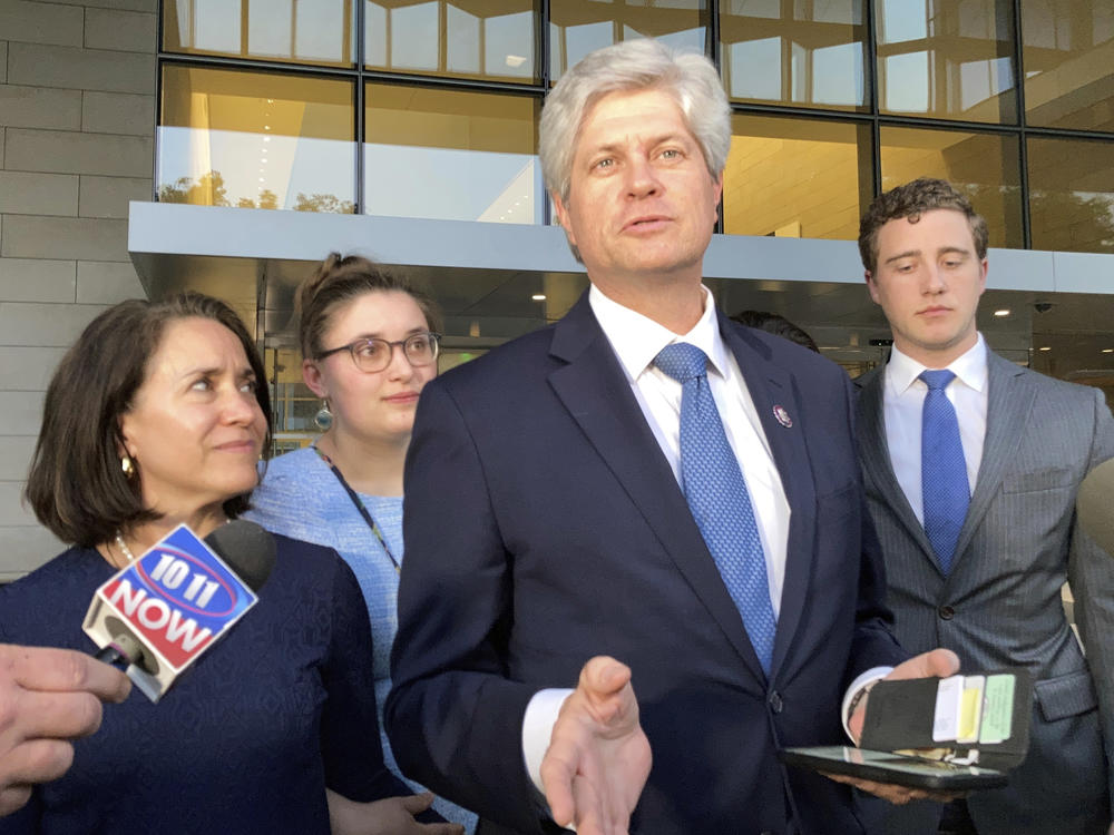 U.S. Rep. Jeff Fortenberry, R-Nebraska, center, speaks with the media outside the federal courthouse in Los Angeles, on Thursday.