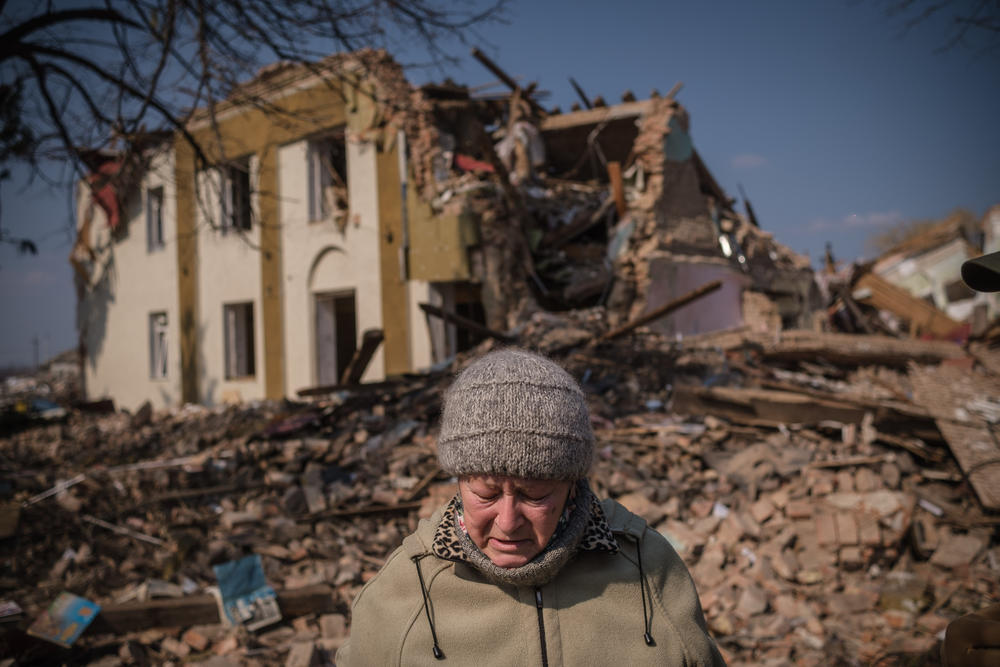 <strong>March 25:</strong> An elderly woman from Bishiv village is seen over the destruction of a library on the outskirts of the city of Kyiv, Ukraine.
