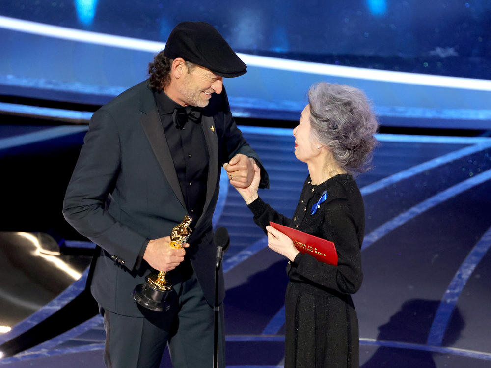 Troy Kotsur accepts the Actor in a Supporting Role award for CODA from Youn Yuh-jung onstage during the 94th Annual Academy Awards at Dolby Theatre on March 27, 2022 in Hollywood, California.