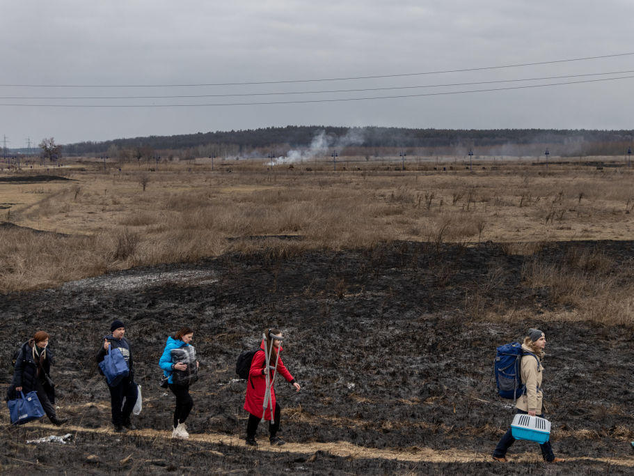 Residents of Irpin, Ukraine, flee heavy fighting via a destroyed bridge as Russian forces entered the city on March 7. On Monday, Ukraine said it was closing humanitarian corridors out of concern about Russian provocations.