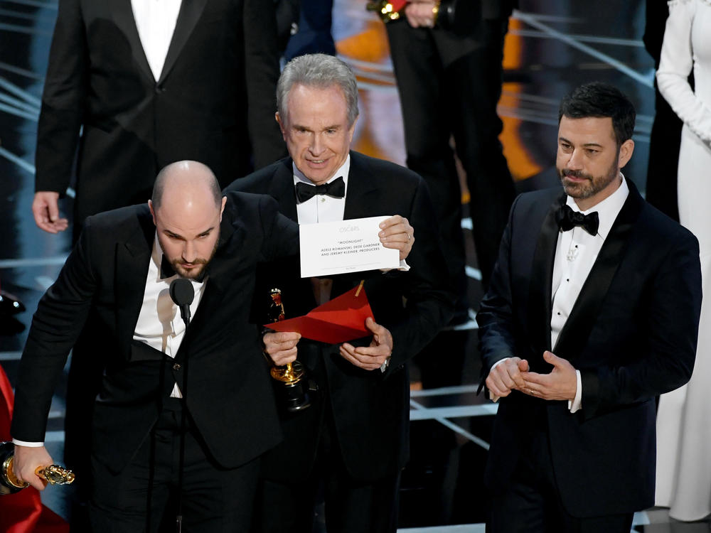 <em>La La Land</em> producer Jordan Horowitz holds up the winner card reading actual Best Picture winner <em>Moonlight</em> with actor Warren Beatty and host Jimmy Kimmel onstage during the Academy Awards in 2017.