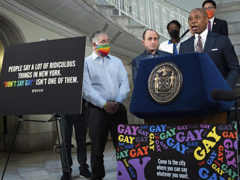 New York Mayor Eric Adams, at podium, addresses a news conference in the rotunda of City Hall, in New York, on April 4. New York City is launching a digital billboard campaign, supporting LGBTQ visibility that will be displayed in five major markets in Florida for eight weeks, to lure Floridians unhappy with their state's 