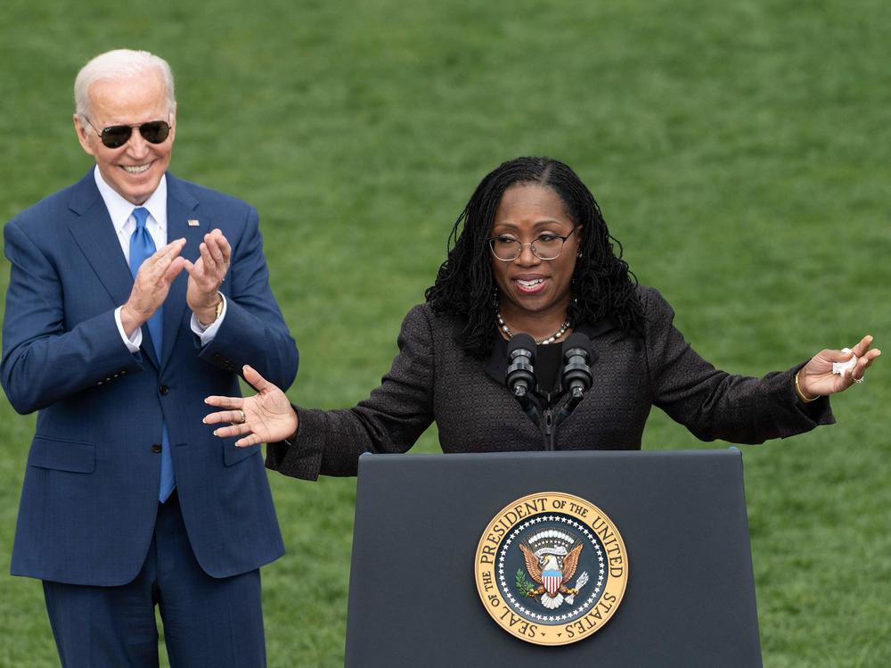 Judge Ketanji Brown Jackson speaks as President Biden reacts at an event celebrating Jackson's confirmation to the Supreme Court on the South Lawn of the White House on Friday.