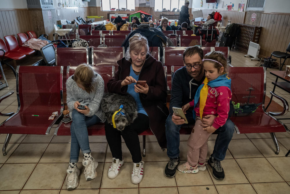 Ukrainian refugees Sofia Kotlyarova, 11, from Kyiv, and her grandmother, Lydia Melnik, sit in one of the waiting rooms at Gara de Nord railway station. After arriving in Romania, they became friends with another family of refugees, Dmytro Ishchuk and his 5-year-old daughter, Dana, from Kharkiv.