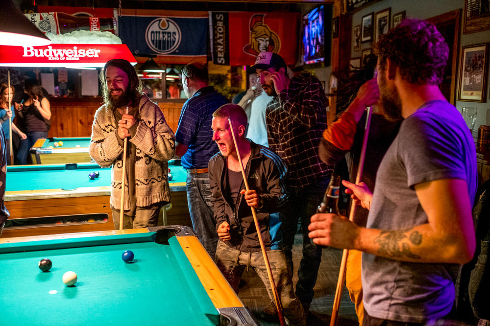 Planters play pool in a bar in central Alberta. Nights off are when planters bond and strengthen the social dynamics of the camp. For many planters, nights off are what keep them coming back year after year.