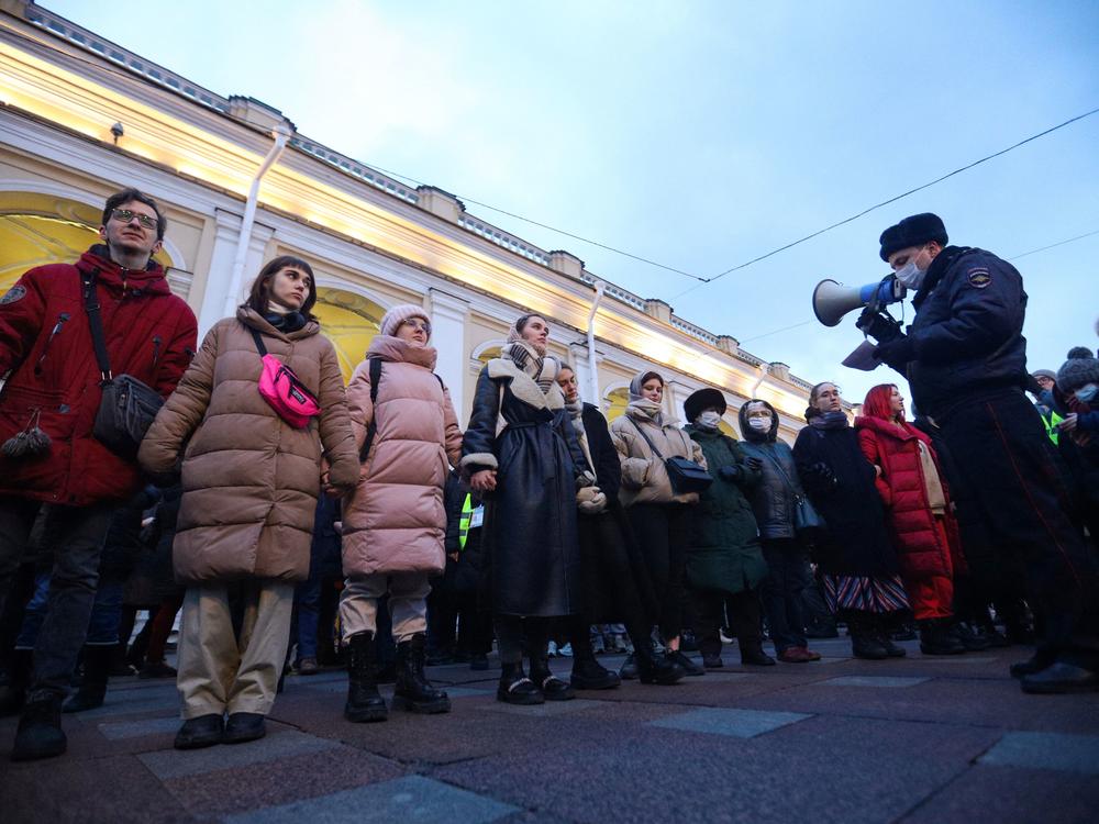A police officer uses a loudspeaker to address people gathered in St. Petersburg to protest Russia's invasion of Ukraine on Feb. 24.