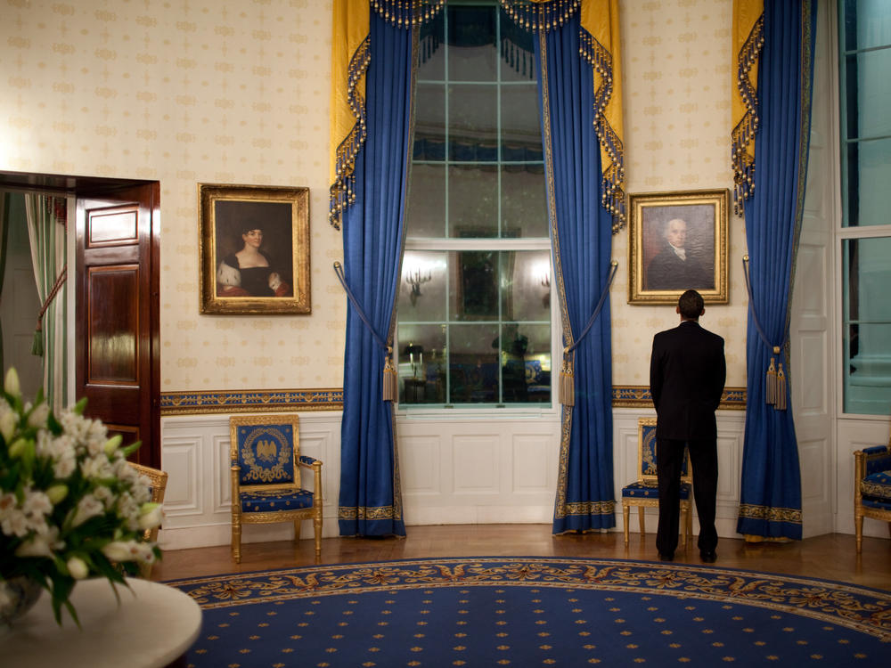 President Barack Obama looks at a portrait of President John Adams while waiting in the White House's Blue Room prior to a news conference in the East Room on Feb. 9, 2009.